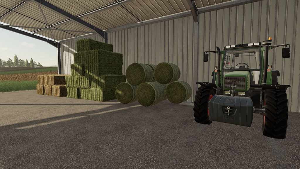 Bales stacked, protected by a shed